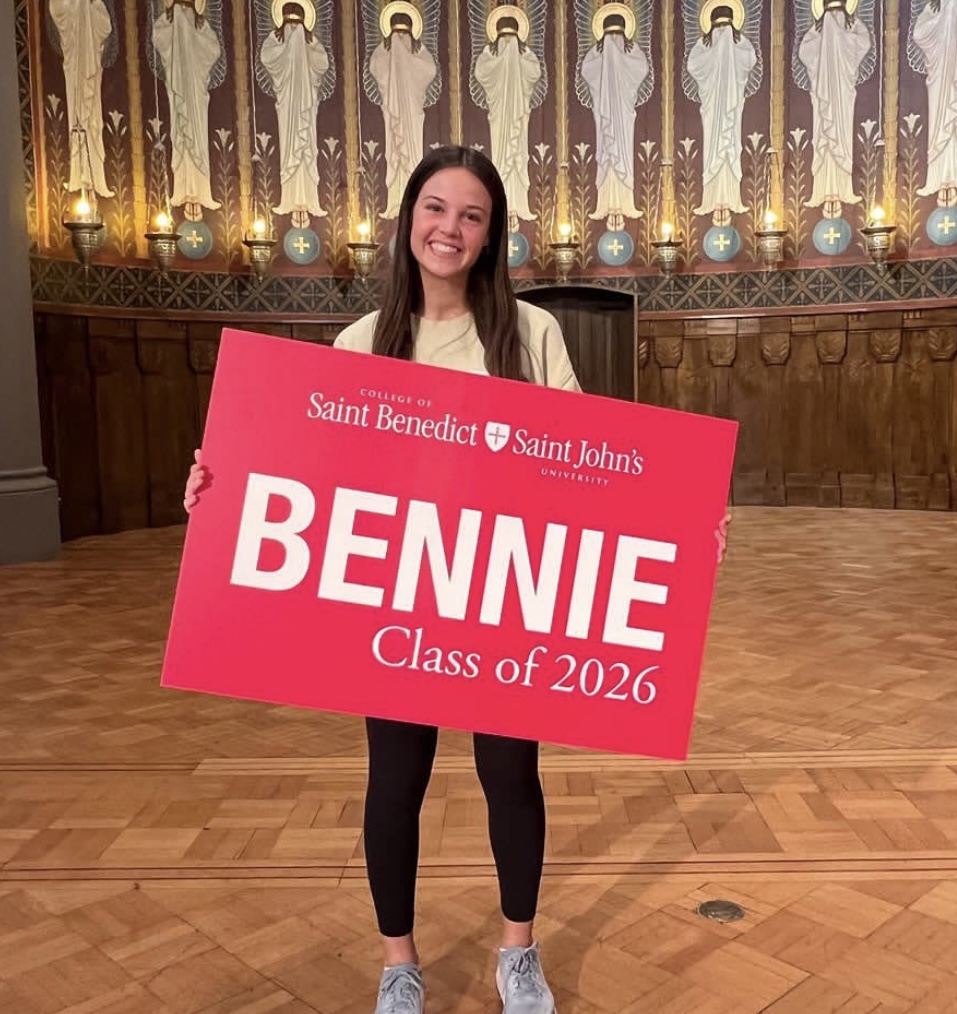 First year Bennie holding welcome class of 2026 sign in Great hall. 