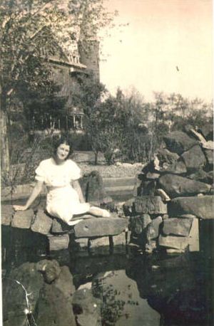Student sitting by a pond