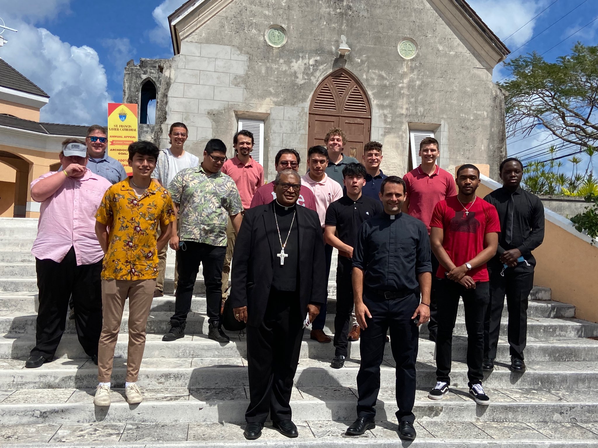 Group of religious leaders and college students standing in front of a church in The Bahamas