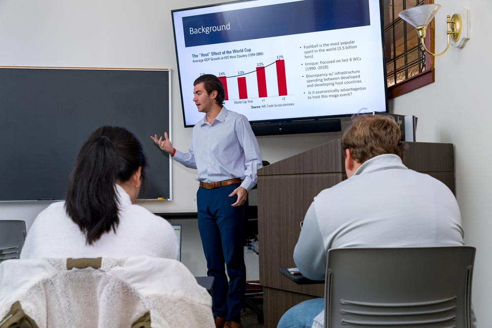 An instructor teaches a class in finance