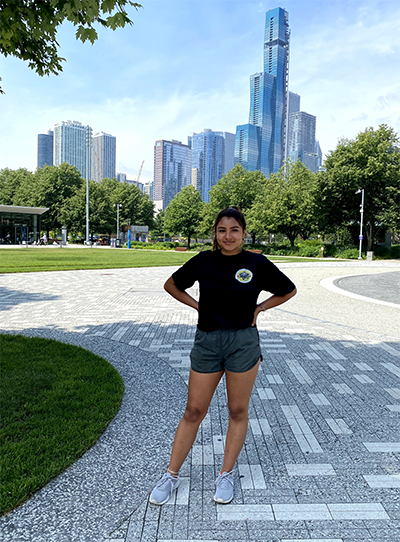 Crystal Diaz running in a city park.