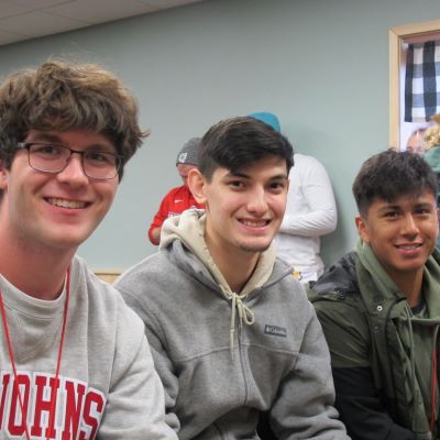 Three college men looking forward smiling