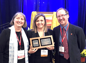 Pictured is Donelle Poling, Associate Director of Youth in Theology and Ministry with S. Stephanie Spandl, SSND and Greg Darr, Maryknoll missionaries who nominated YTM and presented the award.