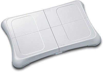 Image of a rectangular white balance board with a sleek design, marked with grid lines and a small power button on the base, branded with "Wii" on top. The surface appears slightly textured for grip.