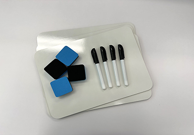 A set of whiteboard materials, including three rectangular whiteboards, four black dry erase markers, and four square erasers in black and blue, arranged on a white surface.