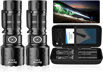 Two black tactical flashlights are shown with a carry case, charging cable, and manual. A small image depicts one flashlight illuminating a forested area at night with a powerful beam.