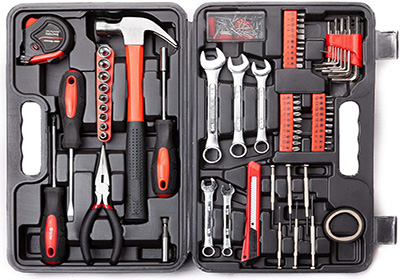 A toolbox containing various tools including a hammer, tape measure, screwdrivers, pliers, wrenches, Allen keys, and sockets, neatly organized into a black plastic case with handles.