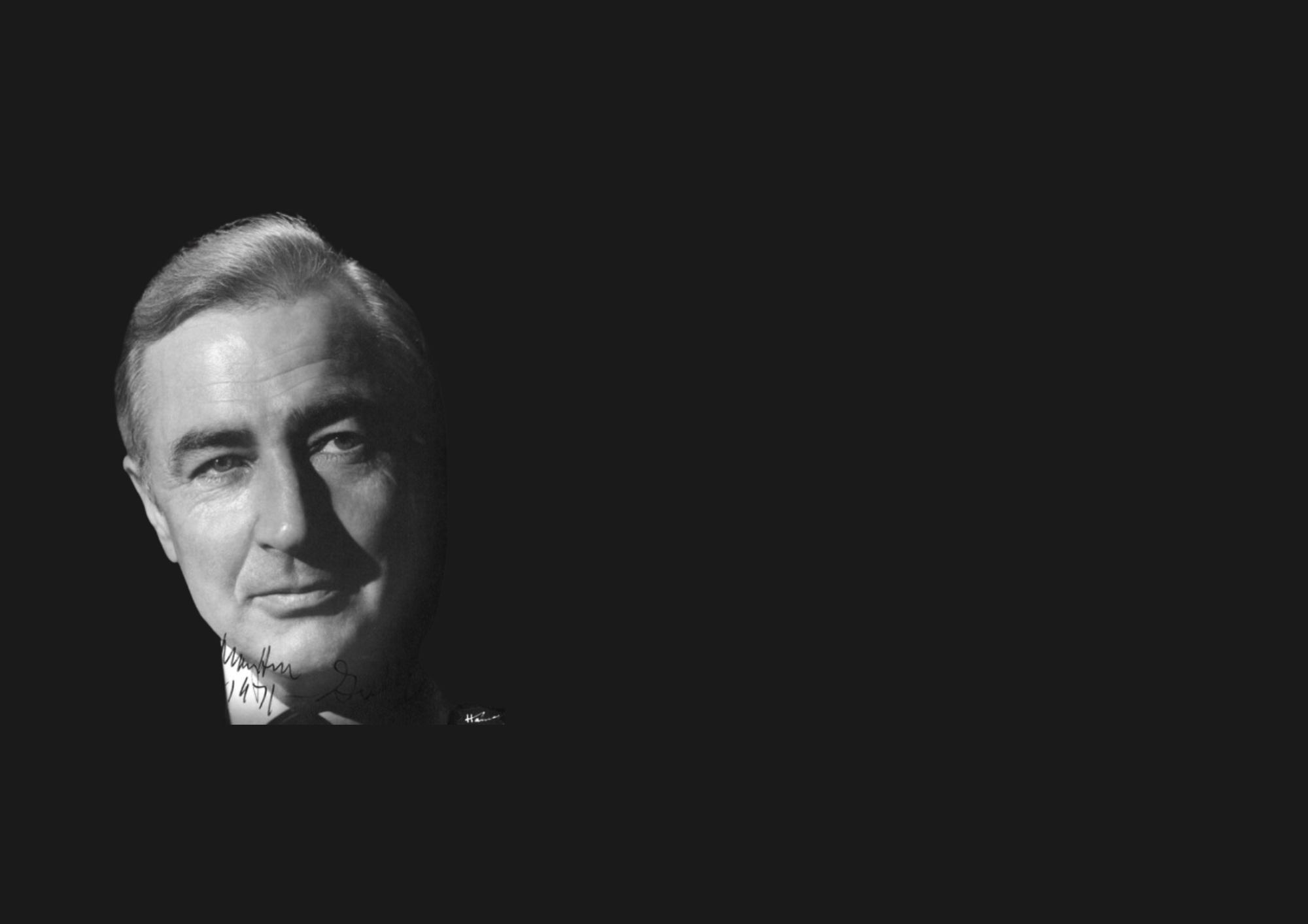 A black and white portrait of an older, suited man with light hair against a dark background, positioned on the left side of the image, with ample negative space on the right.