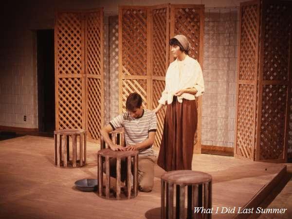 Two actors perform a scene on stage with wooden lattice panels in the background. One actor is seated, holding a bowl, while the other stands, touching the seated actor's shoulder. Text reads "What I Did Last Summer" in the corner.