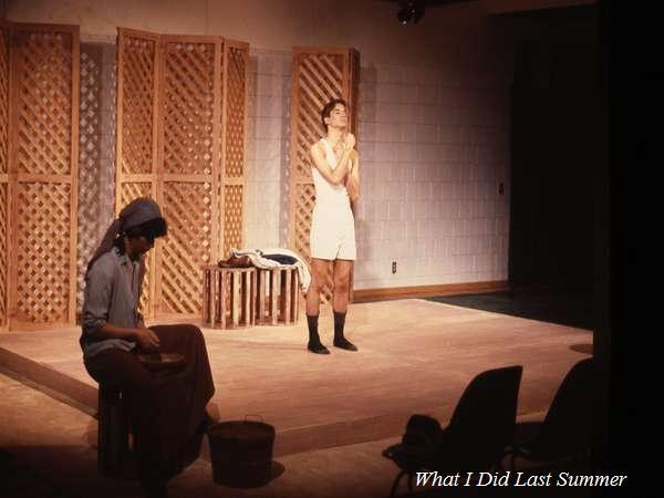 Two actors on stage: one sitting and knitting on the left, wearing a hat and long clothes; the other standing center stage, wearing a white tank top and shorts, with hands at their chin. A screen with a lattice pattern serves as the backdrop. Text: "What I Did Last Summer.