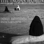 Black and white poster for "The Trojan Women" by Euripides, showing a figure in black, seated on a large rock in a barren landscape. Event details include dates, times, location at Darnall Amphitheater, and contact information for tickets.