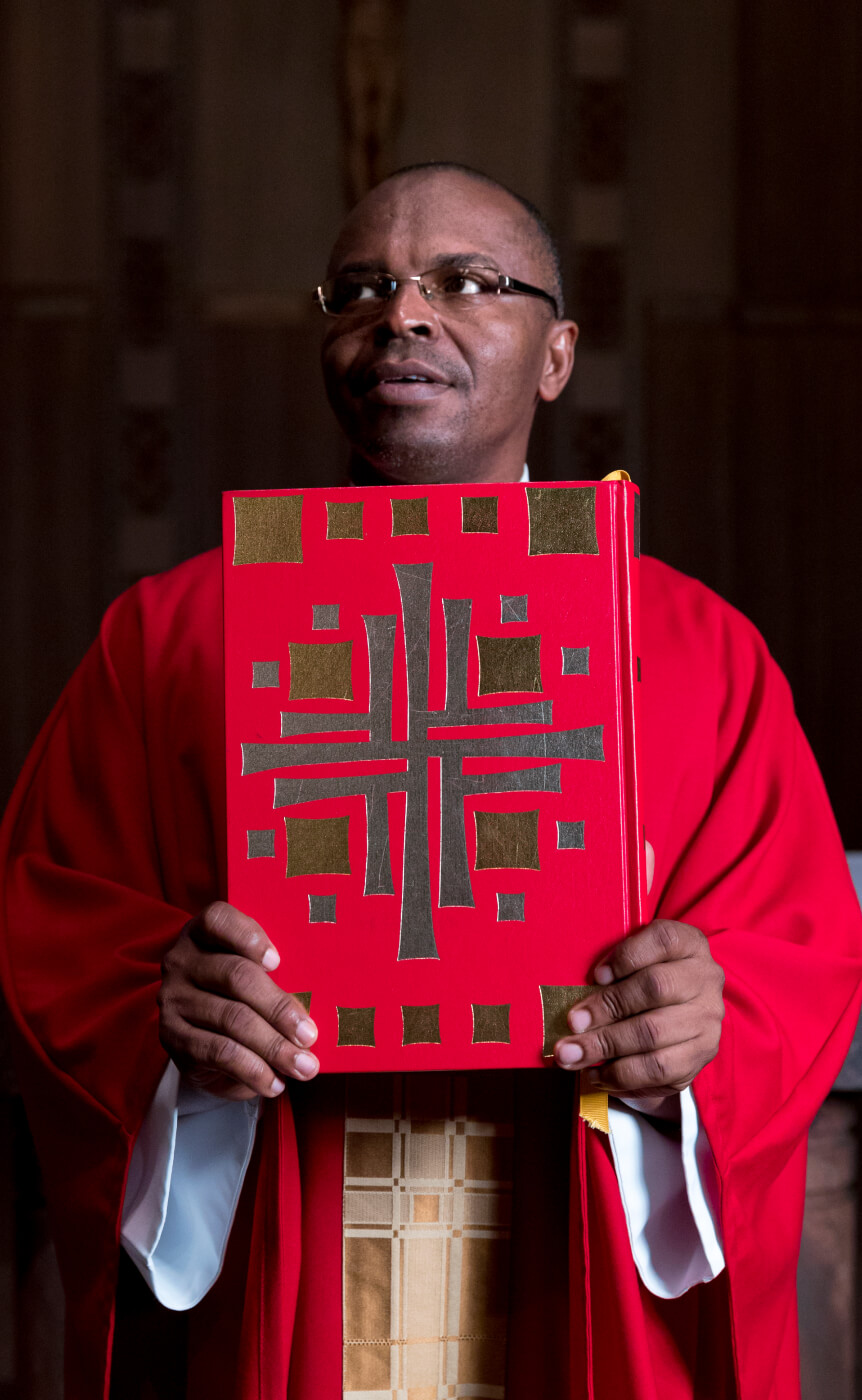 Monastic resident holding a religious text. 