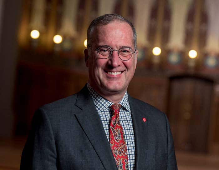 President Brian Bruess wearing a grey suit and red tie. 