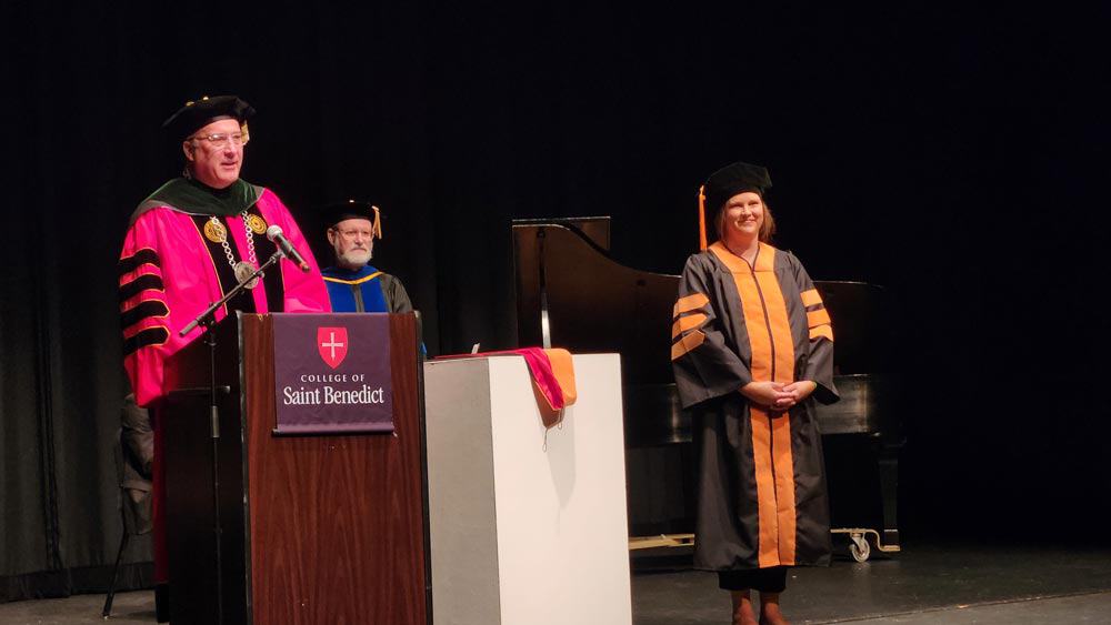 CSB and SJU President Brian Bruess presents Denise Christie with her DNP