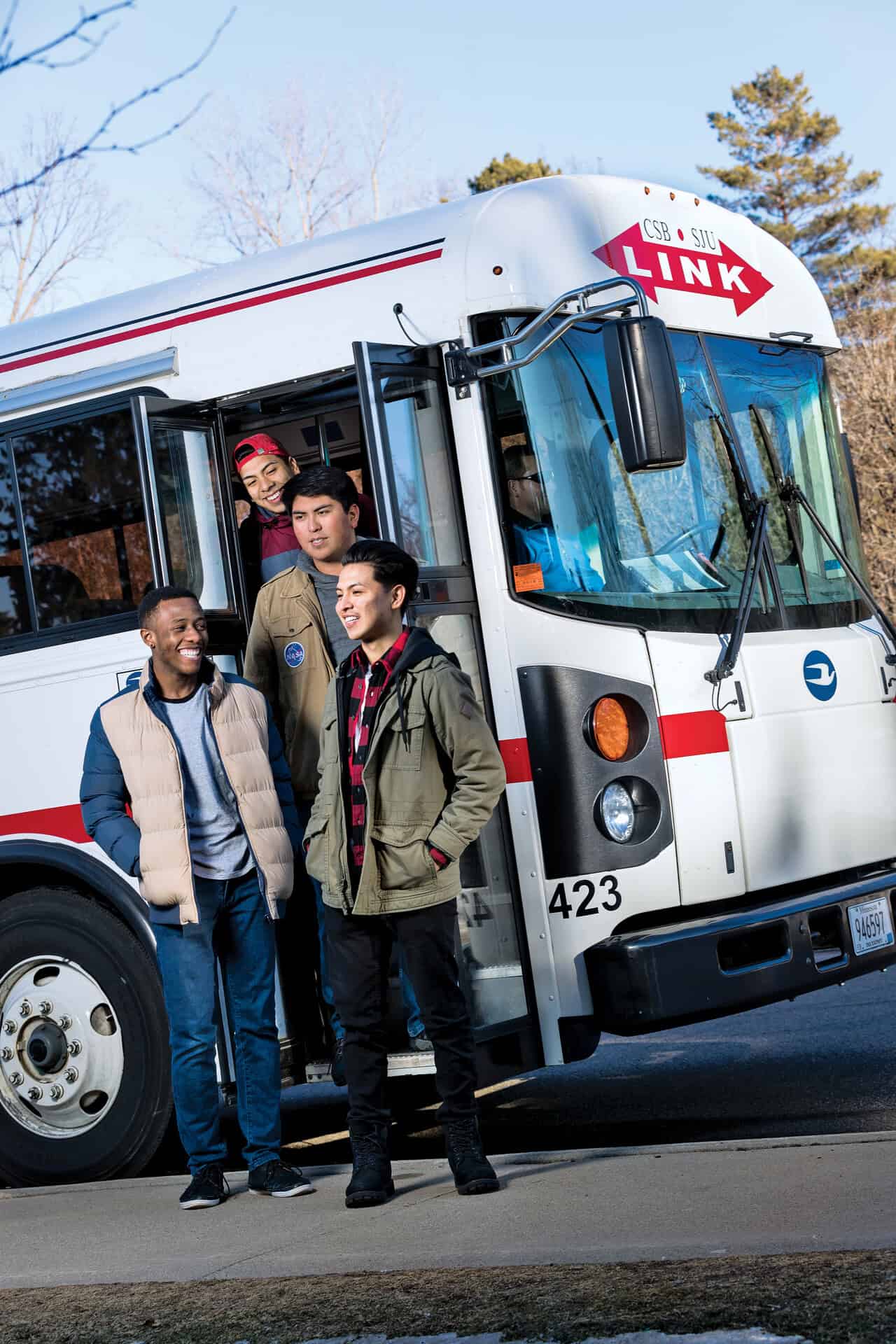 Students hop off the LINK, the institution's transportation service, on their way to a campus event