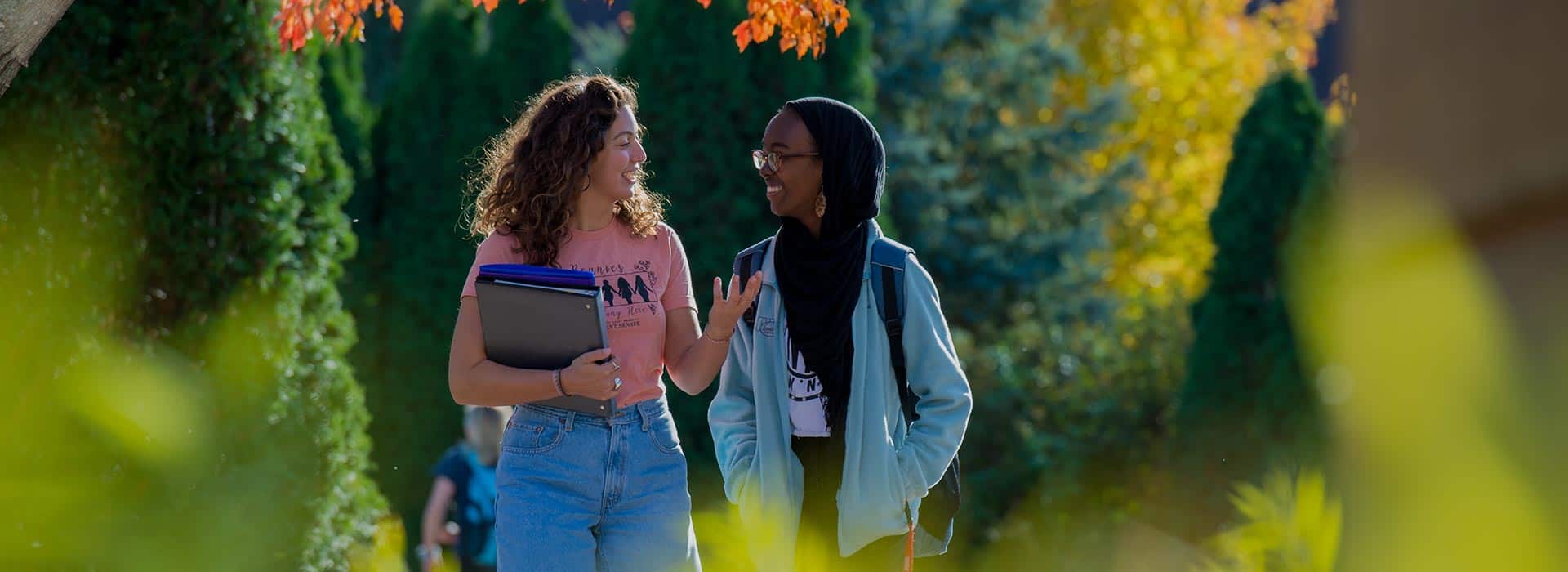 Saint Ben's students enjoy a quick conversation while walking between classes. 